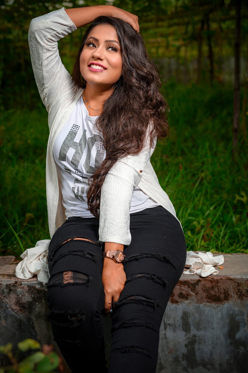 woman wearing white shirt and distressed black jeans